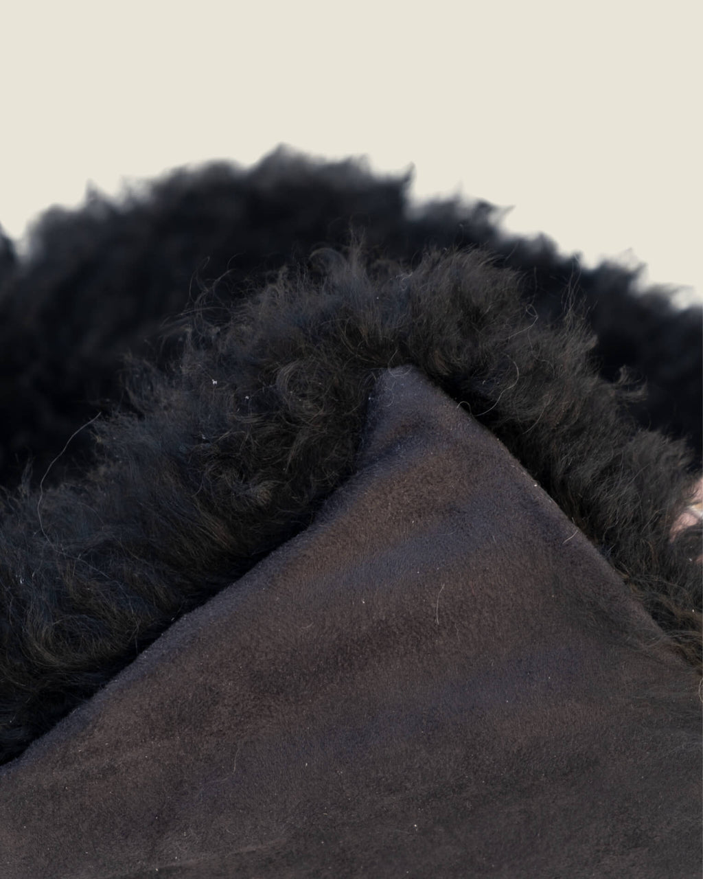 Black mongolian sheepskin pillow close up