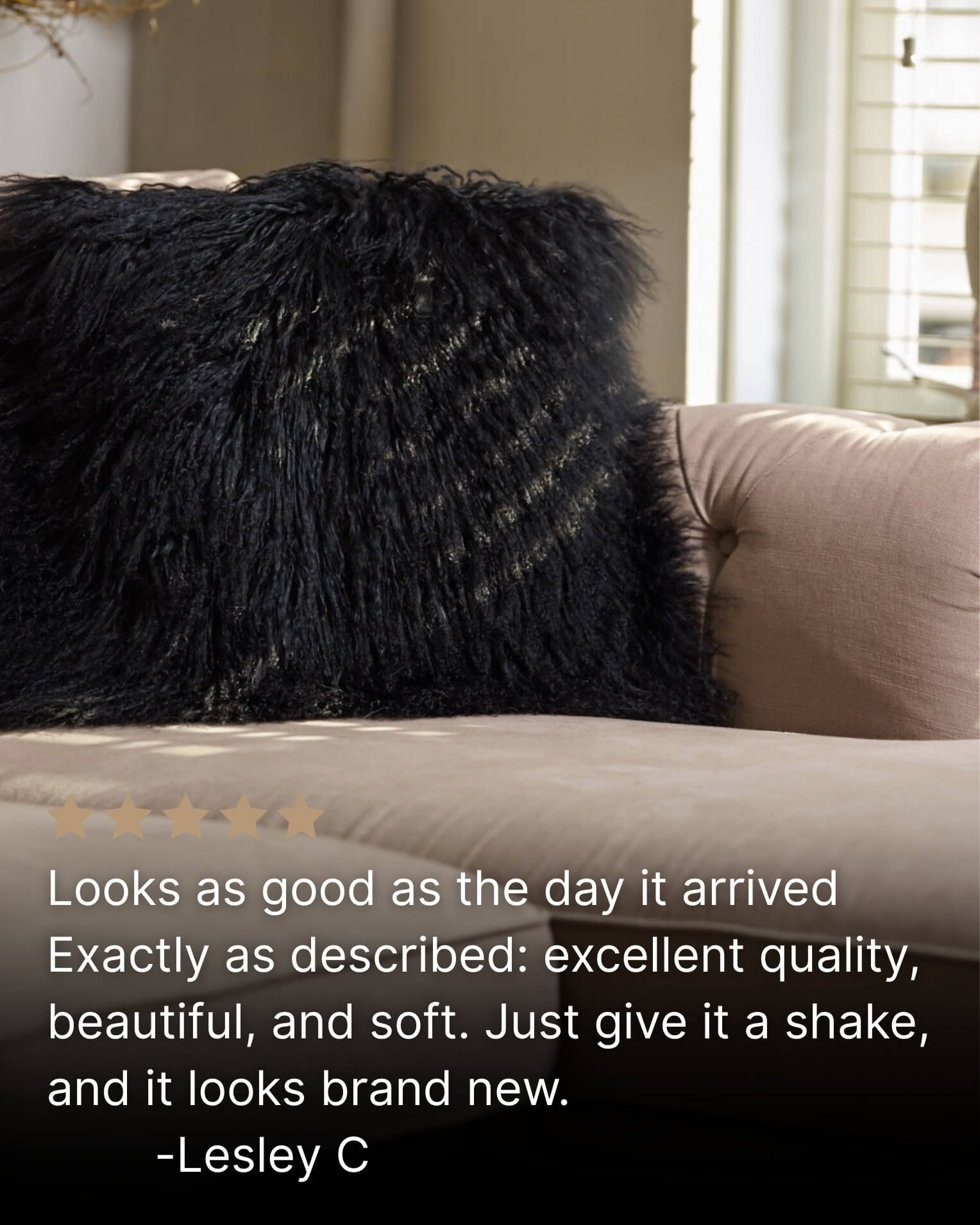Black mongolian sheepskin pillow on brown sofa