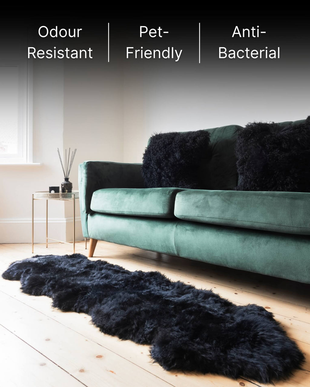 Black mongolian sheepskin pillows on sofa with sheepskin rug.