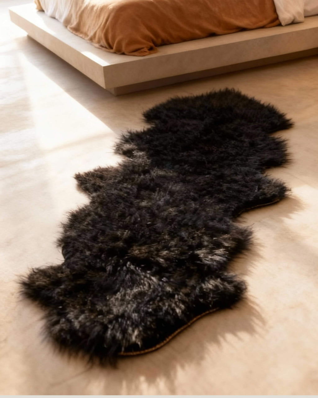 Black Mongolian Sheepskin Rug in bedroom