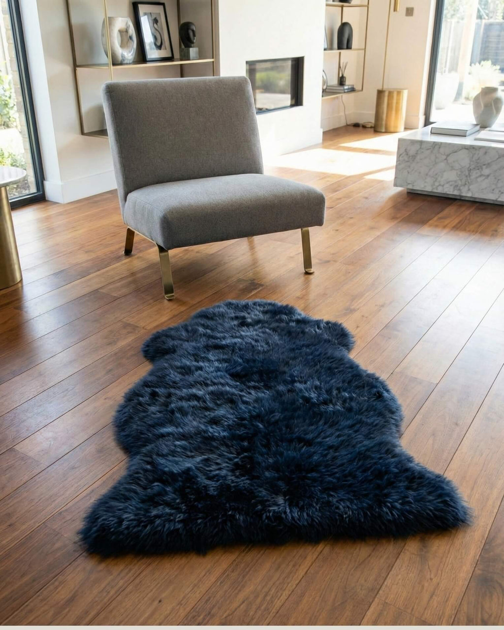 Black Single Sheepskin rug on wooden floor