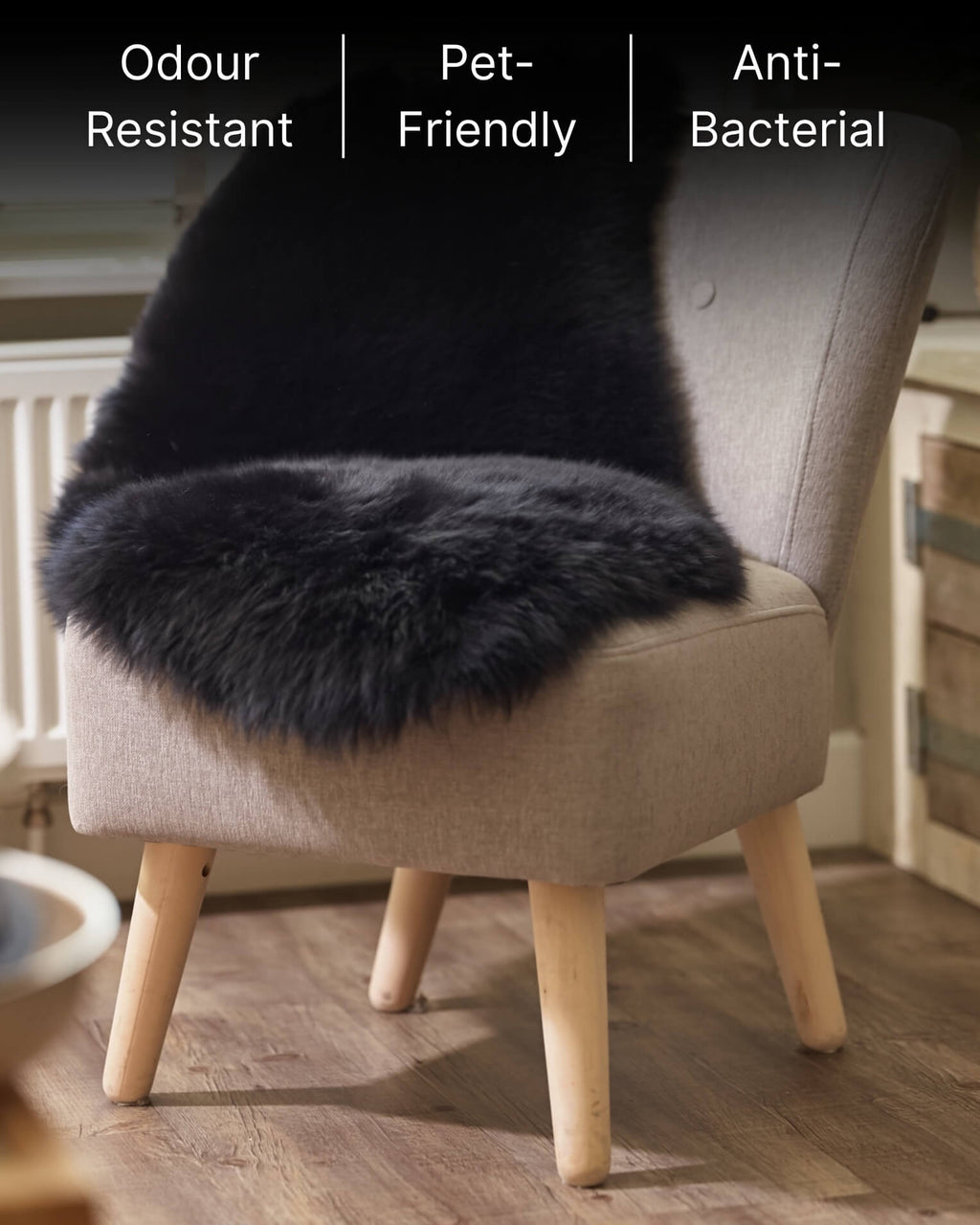 Black sheepskin rug on a beige chair