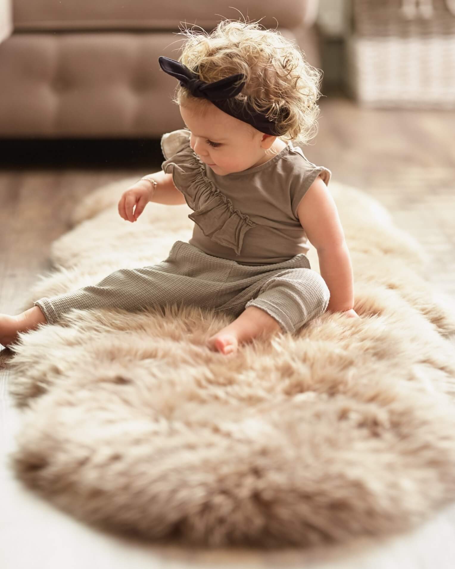 Baby playing on Bronze Double Long Wool Sheepskin Rug 