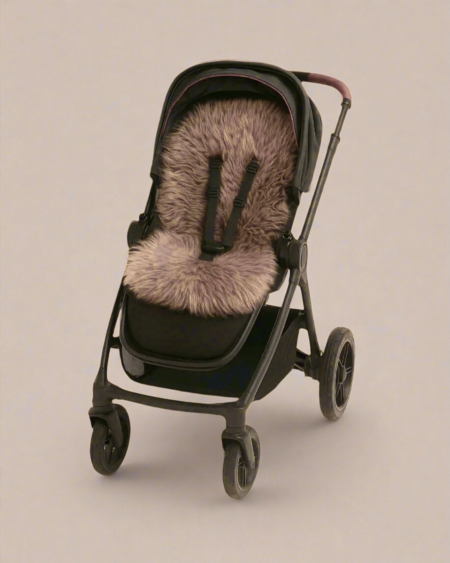 Black stroller with a brown sheepskin pram liner