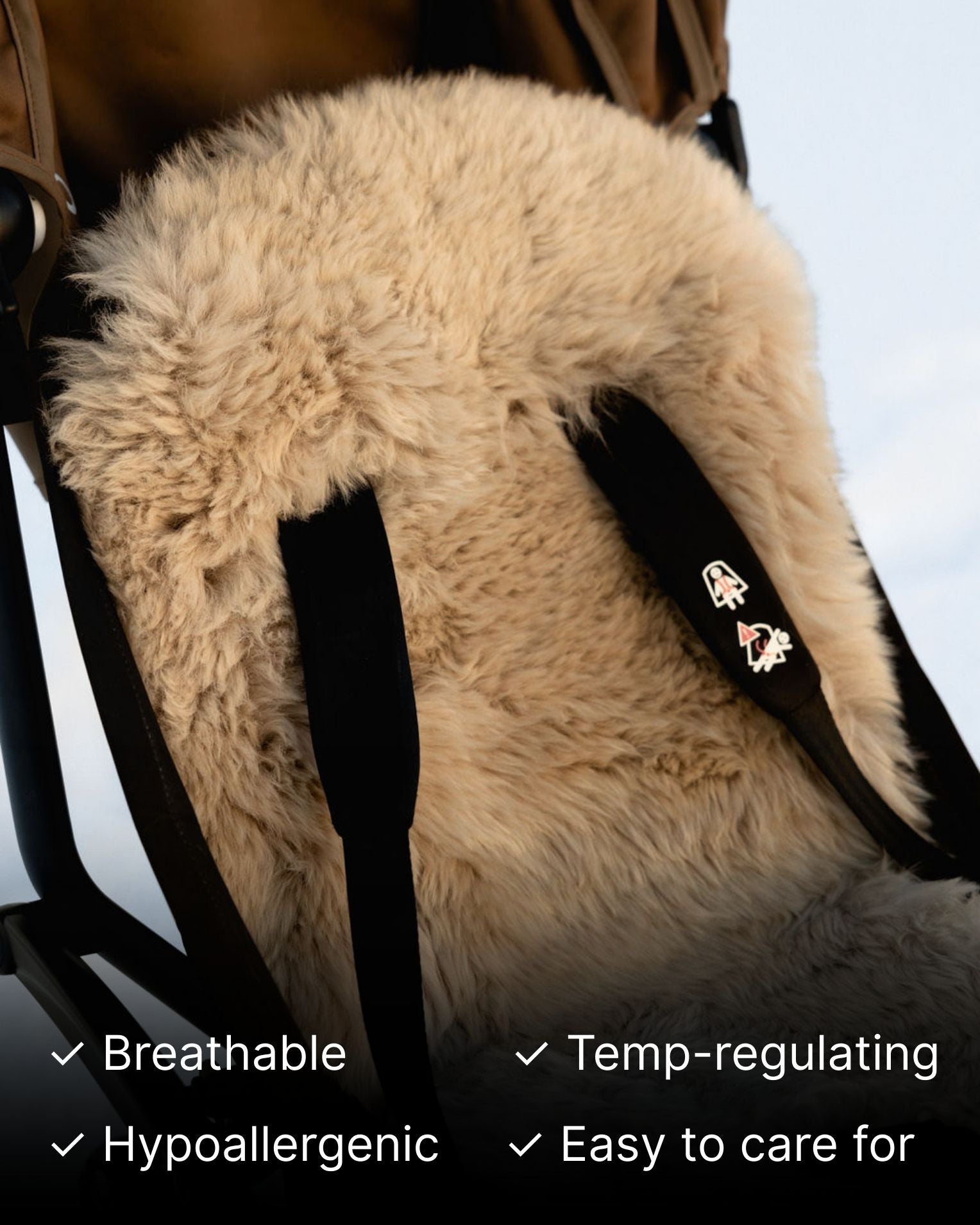 Beige sheepskin seat cover on a stroller