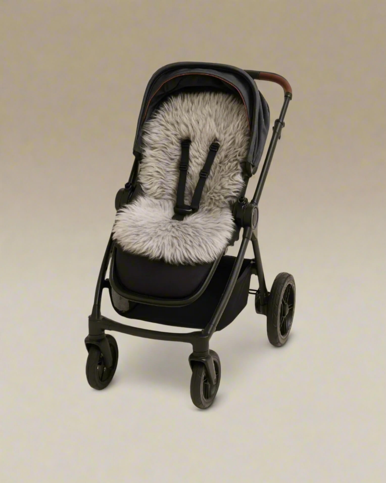 Black stroller with a gray sheepskin pram liner