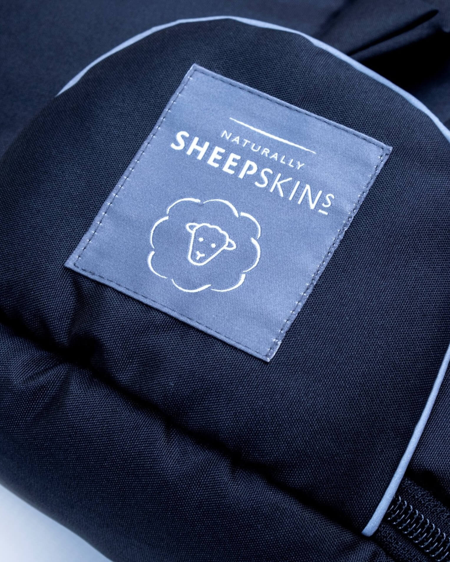 Black baby footmuff naturally sheepskins logo