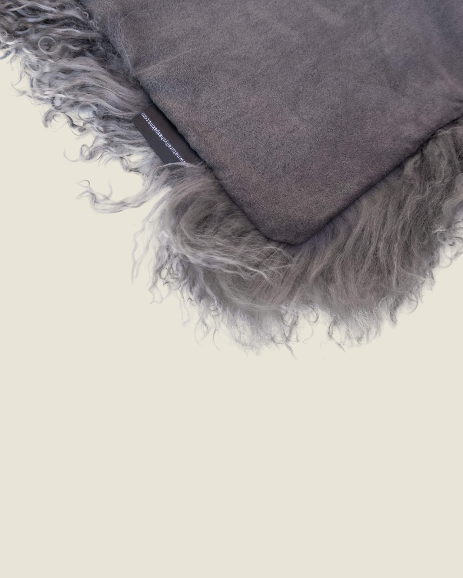 Grey mongolian sheepskin pillow close up off fur