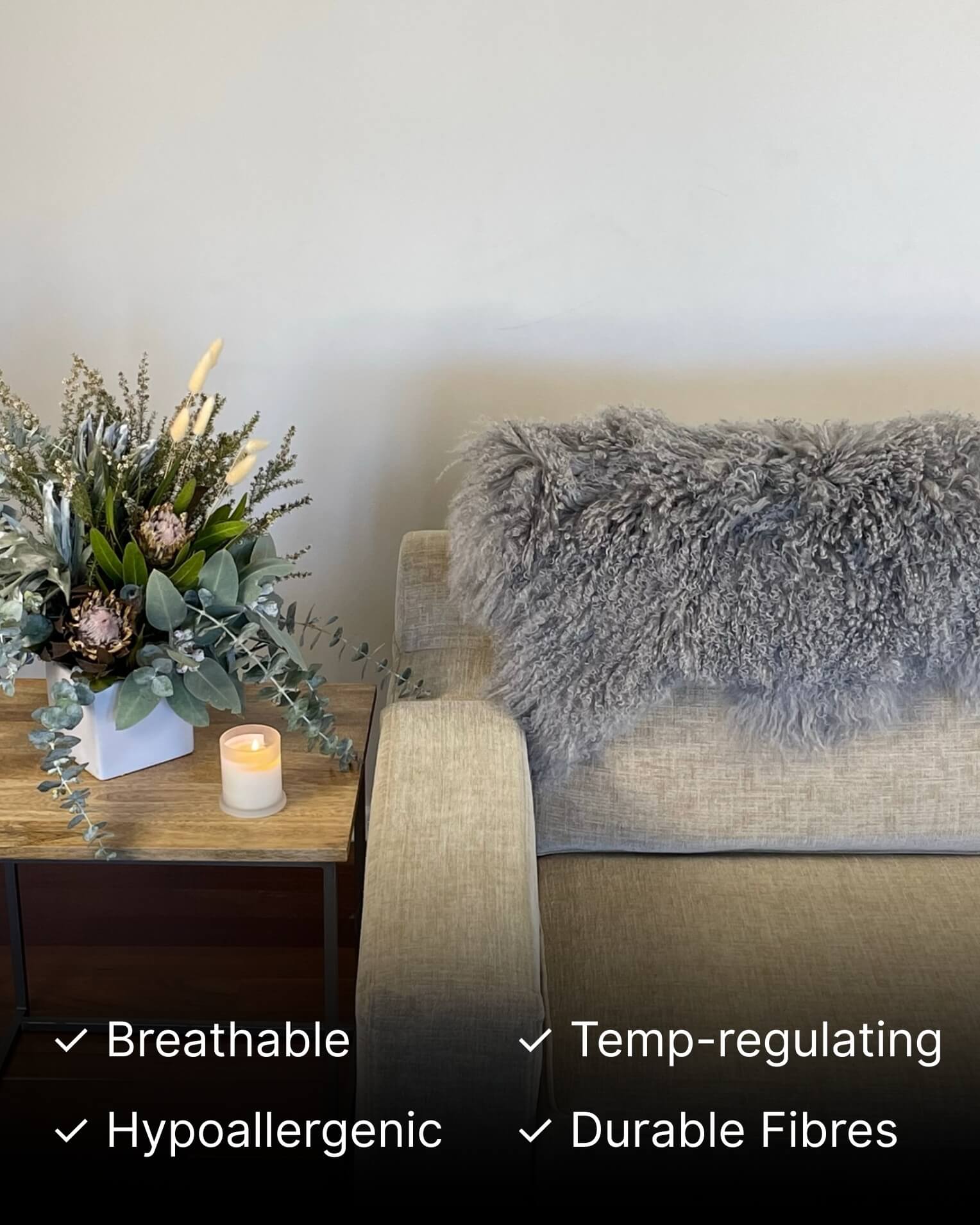 Grey Mongolian Sheepskin Rug on grey sofa