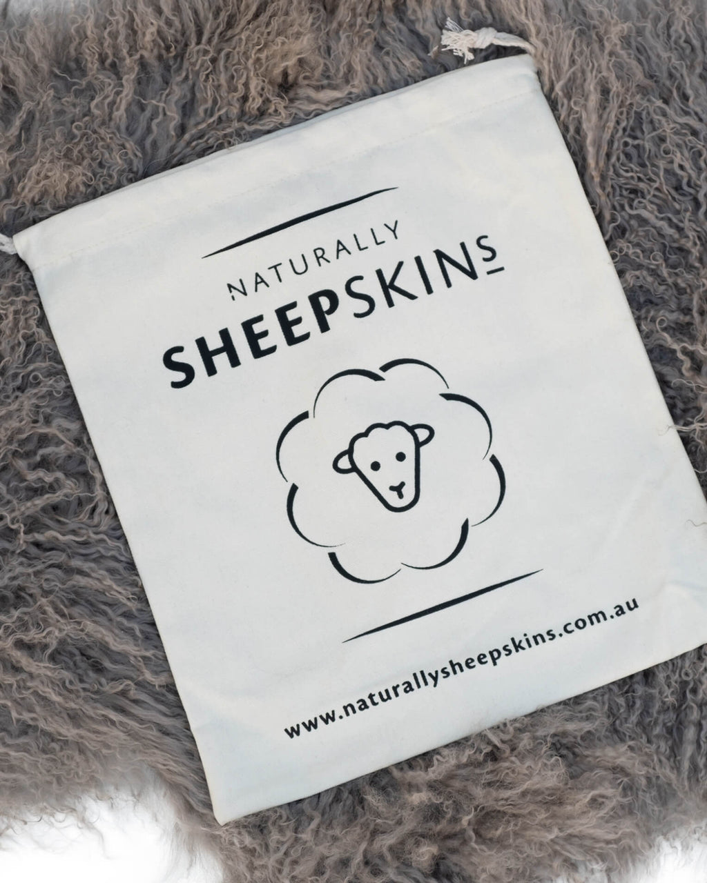 Canvas bag on Grey Mongolian Sheepskin Rug