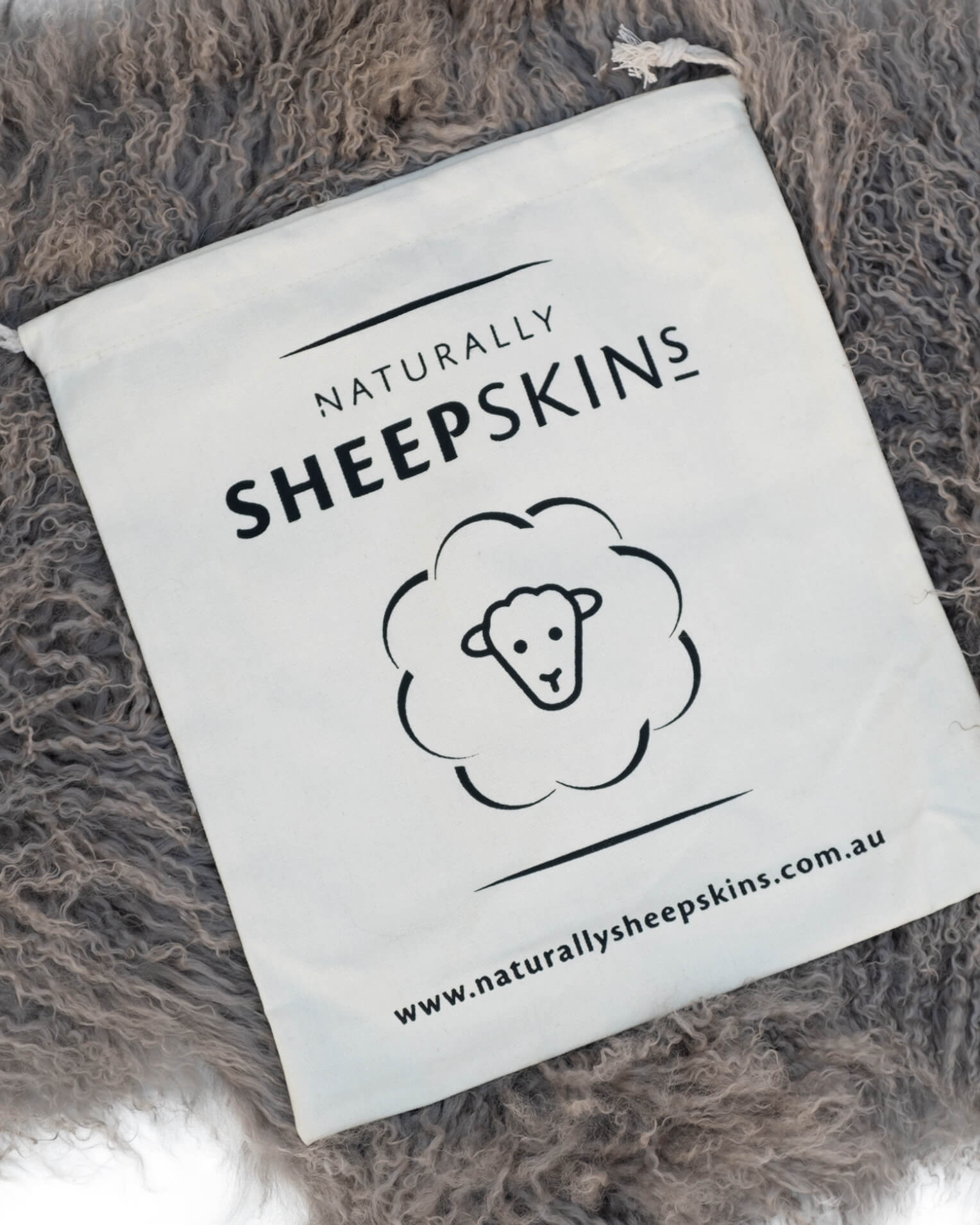 Canvas bag on Grey Mongolian Sheepskin Rug