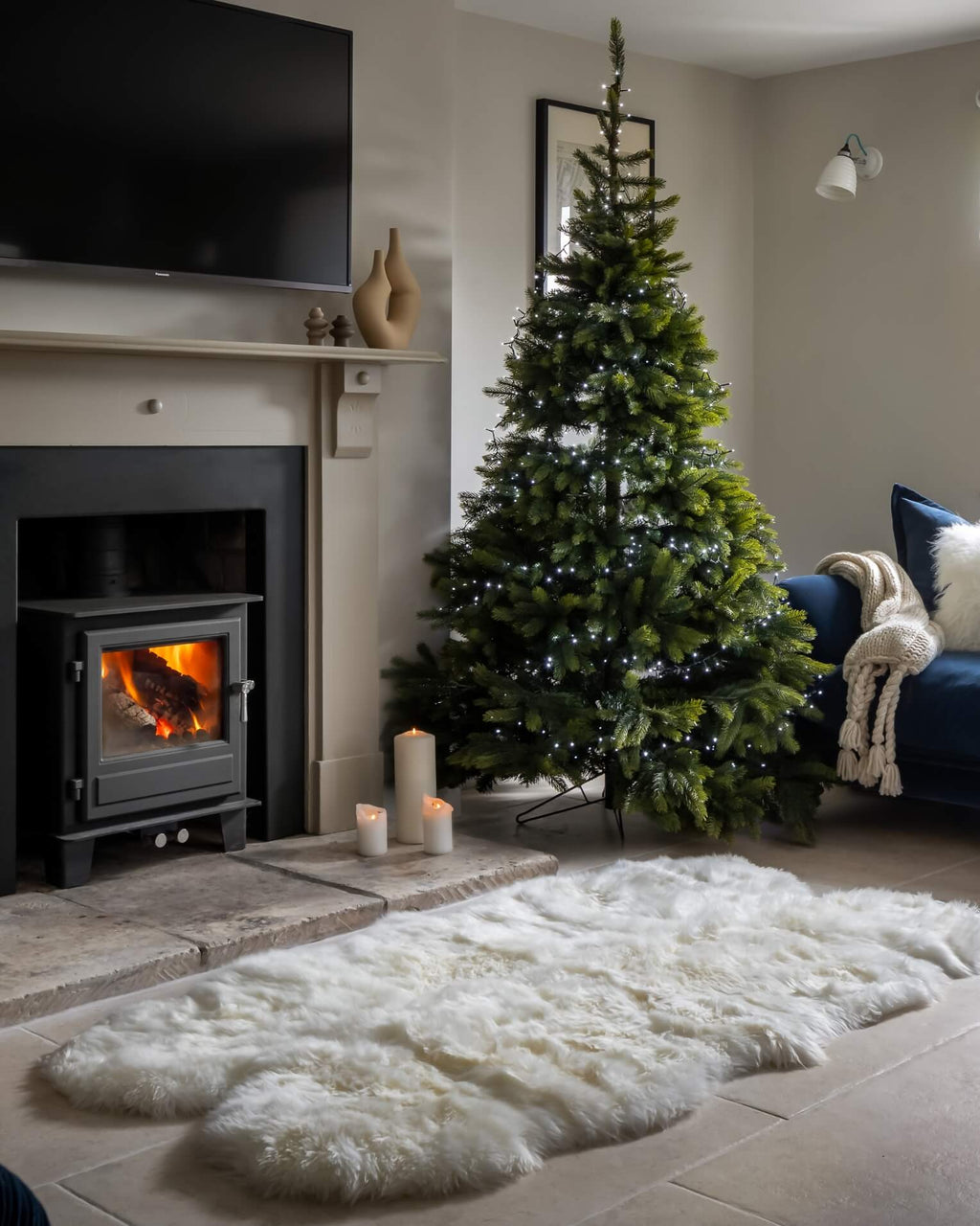 White Quad Long Sheepskin Rug in front of fireplace with christmas tree