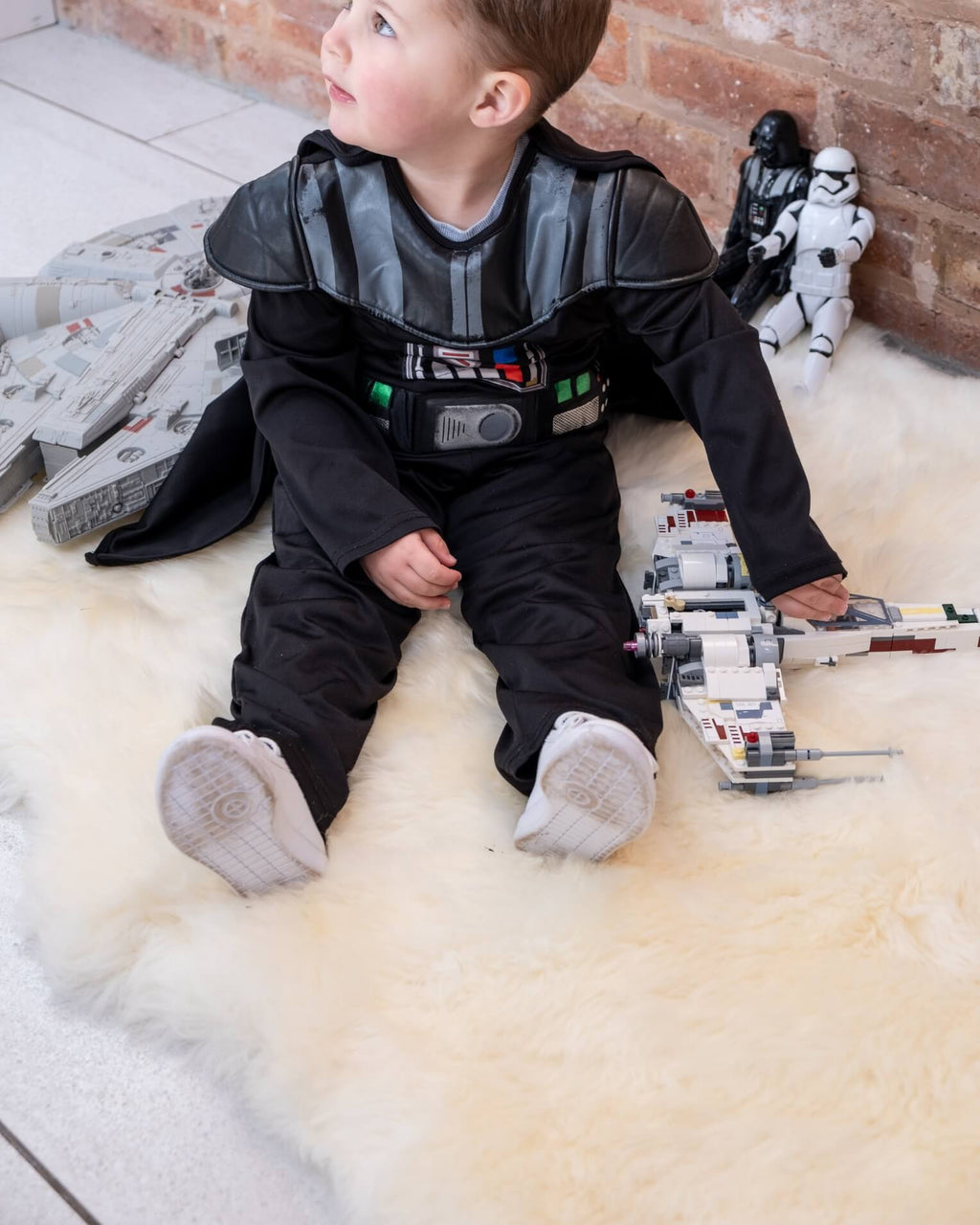 baby sitting on White Quad Long Sheepskin Rug