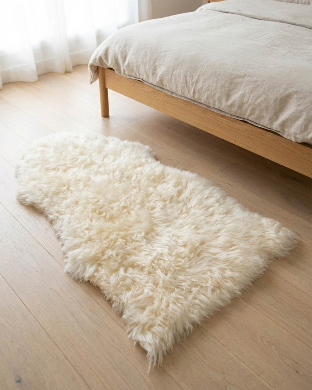 Ivory Single Sheepskin rug next to bed