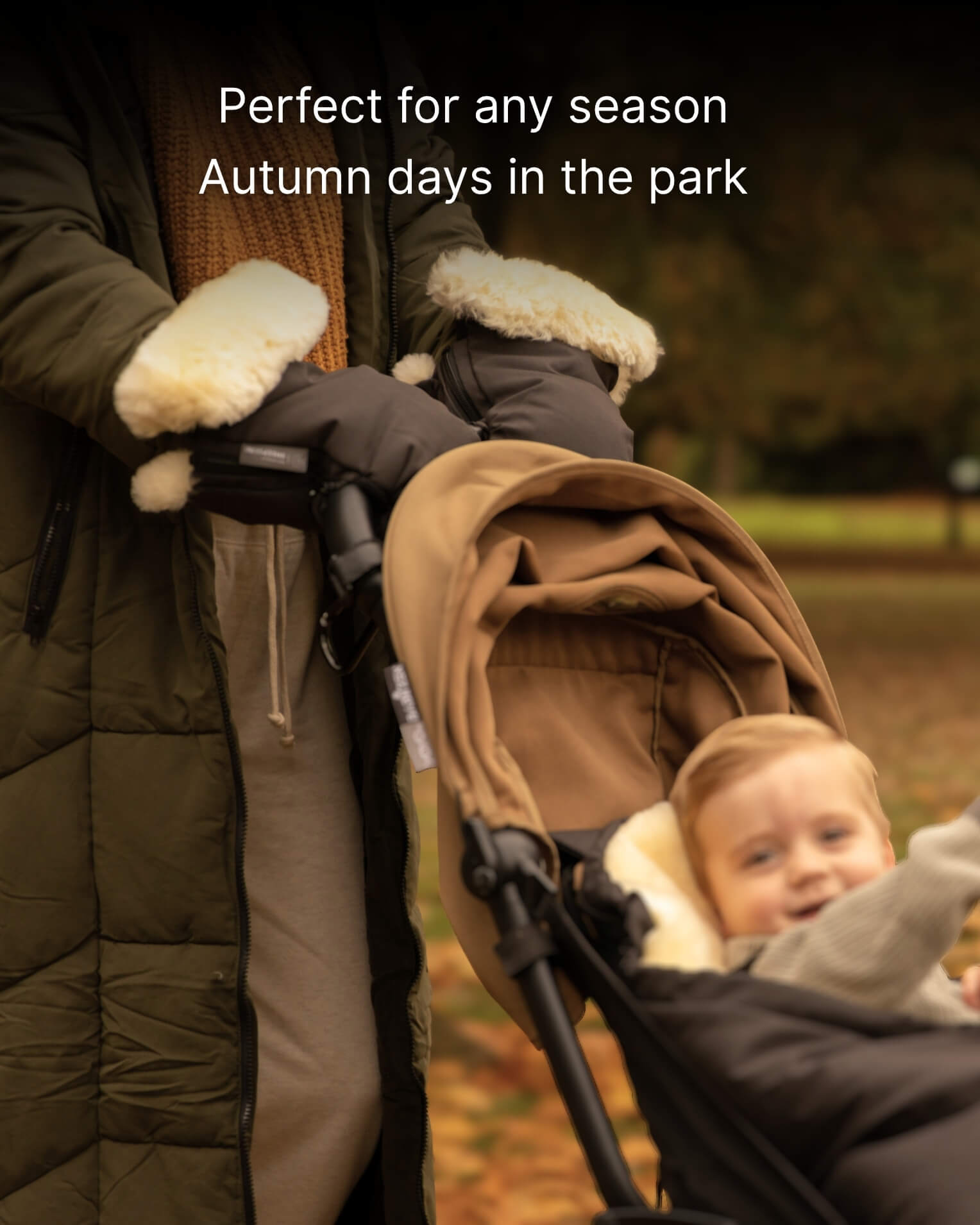 Person pushing a stroller with a child in autumn park setting