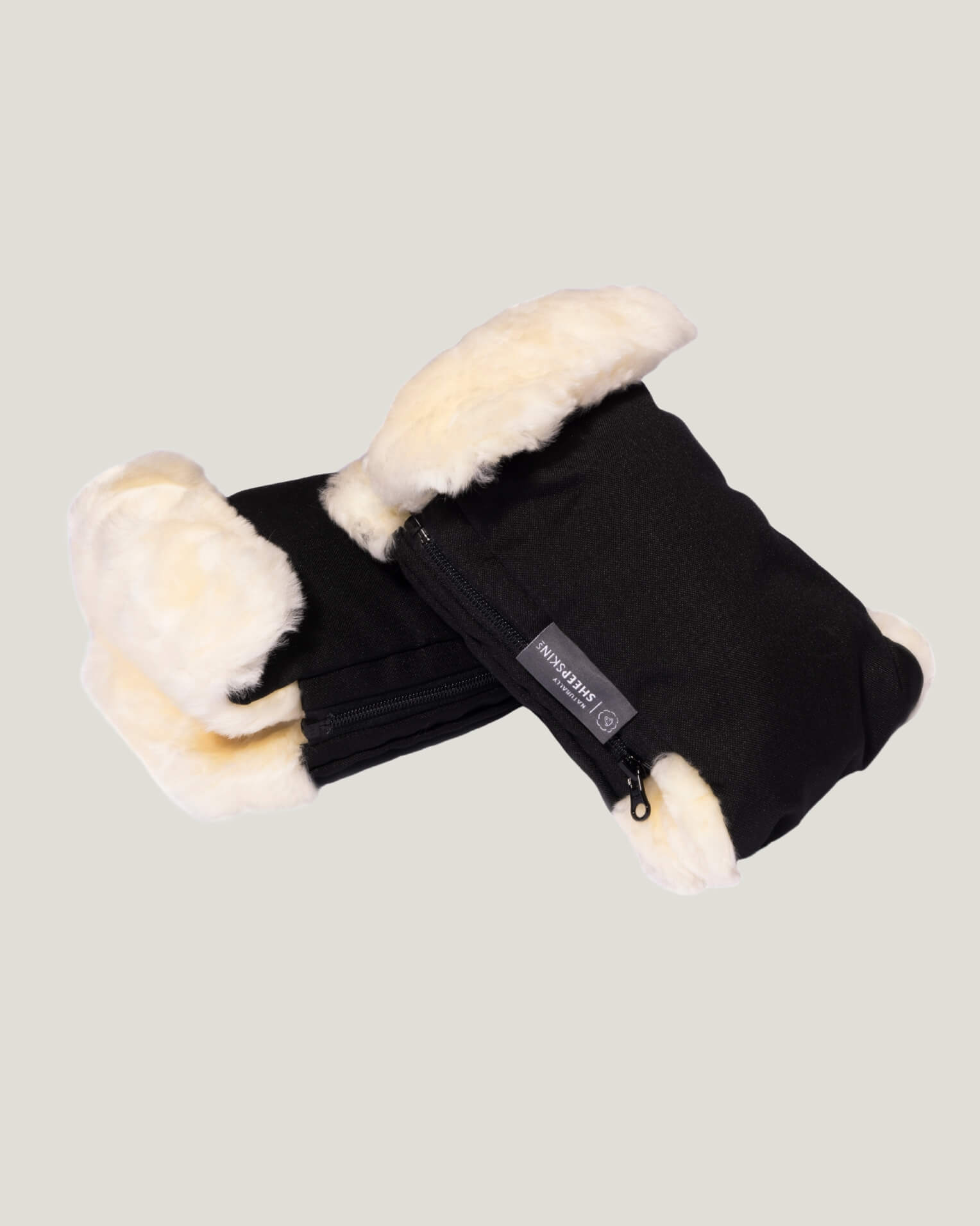 Black sheepskin mittens stacked
