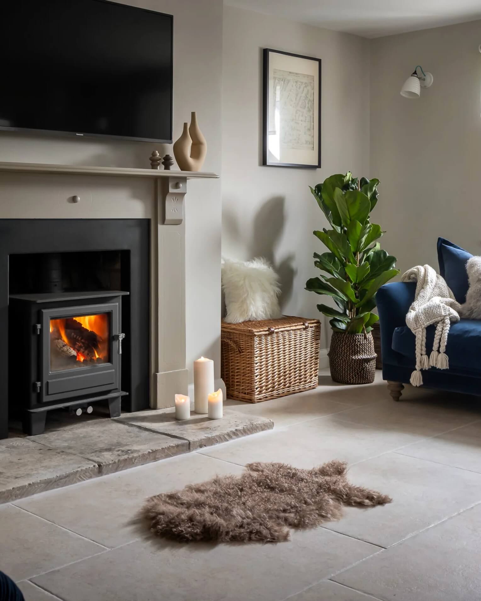 Mocha Mongolian Sheepskin Rug in front of fireplace