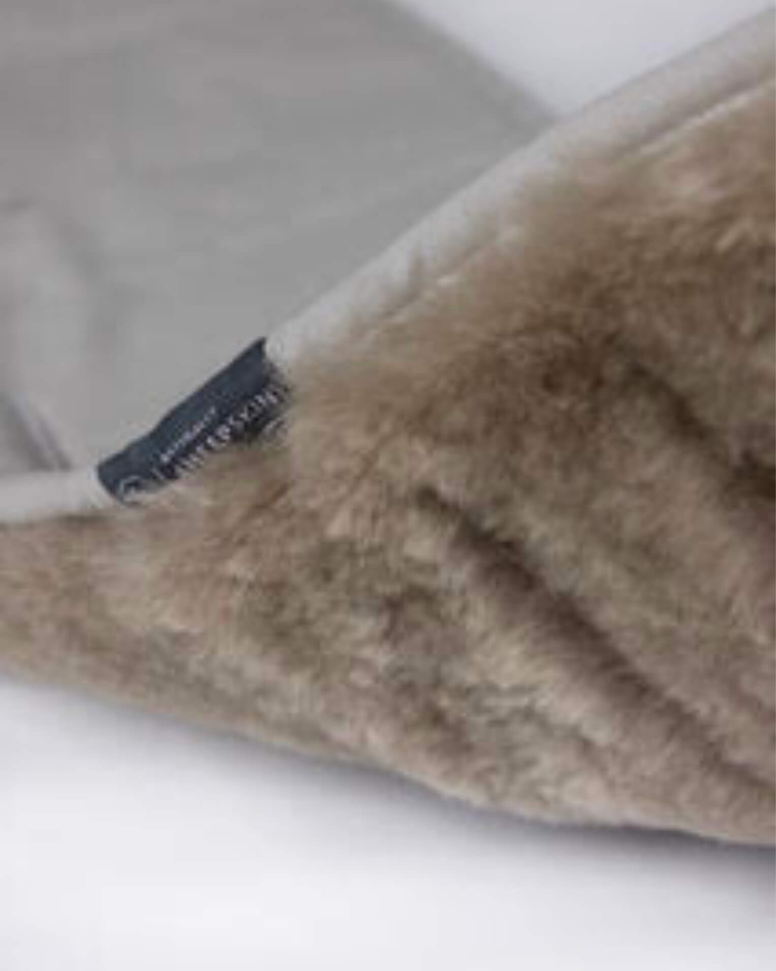 Taupe Sheepskin pramliner close up of fur and back