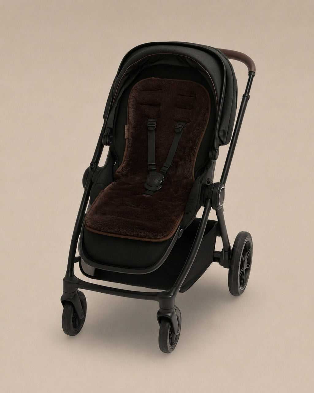 Black stroller with a Chocolate coloured sheepskins pram liner
