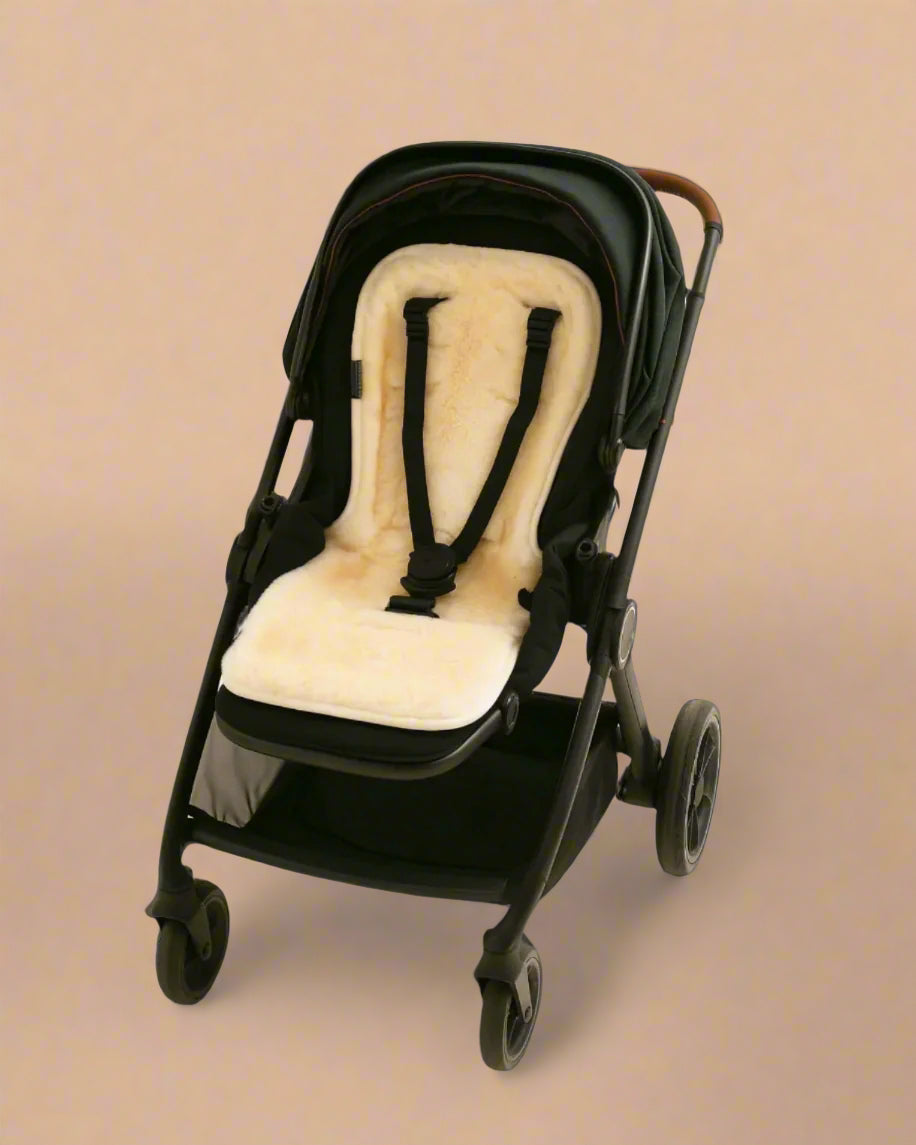 Black stroller with a natural sheepskins pram liner