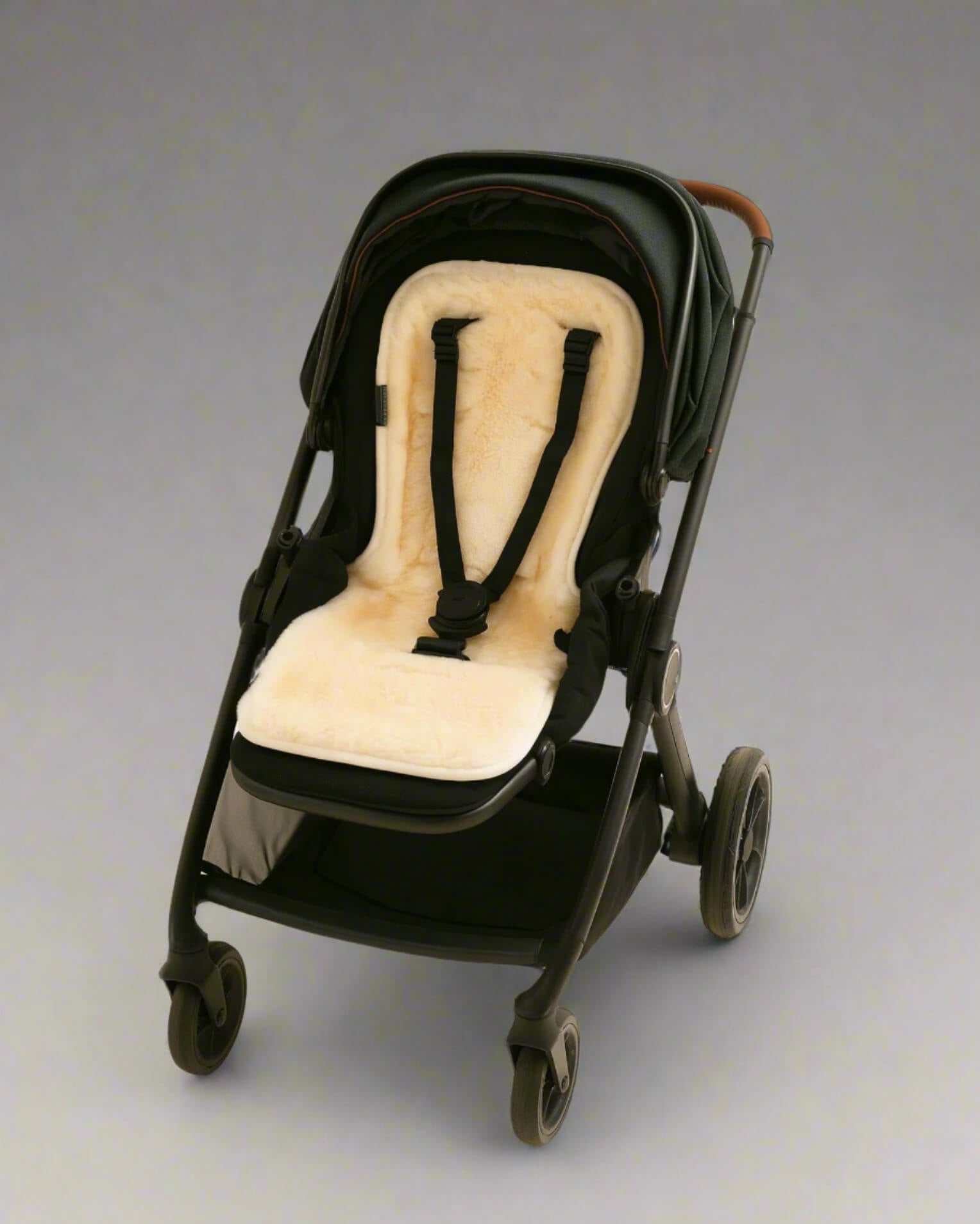 Black stroller with a natural sheepskins pram liner
