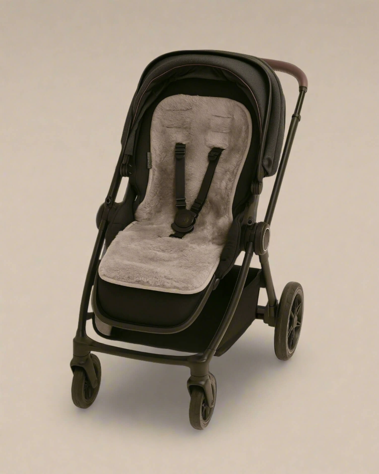 Black stroller with a grey sheepskins pram liner