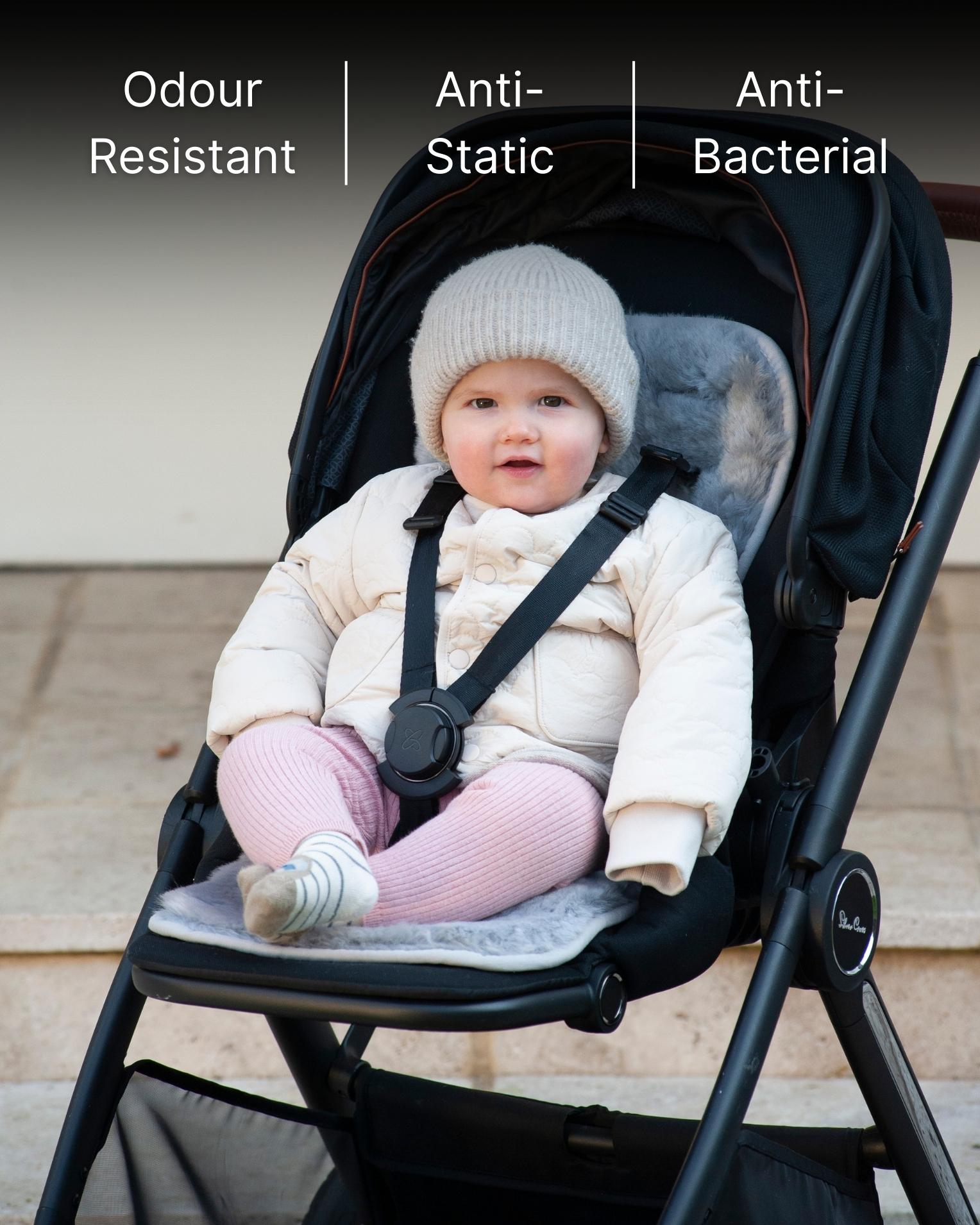 Child in a stroller with skeepskin liner