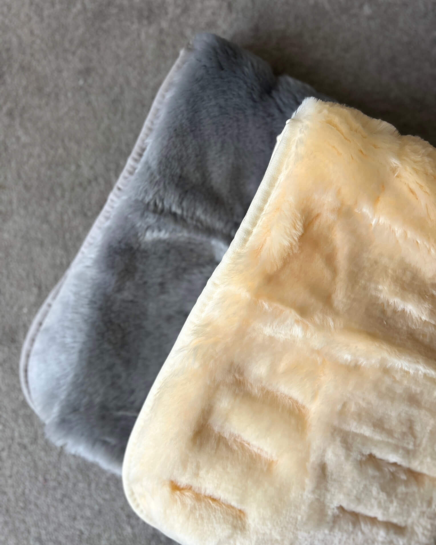 grey and natural sheepskin pram liner on floor