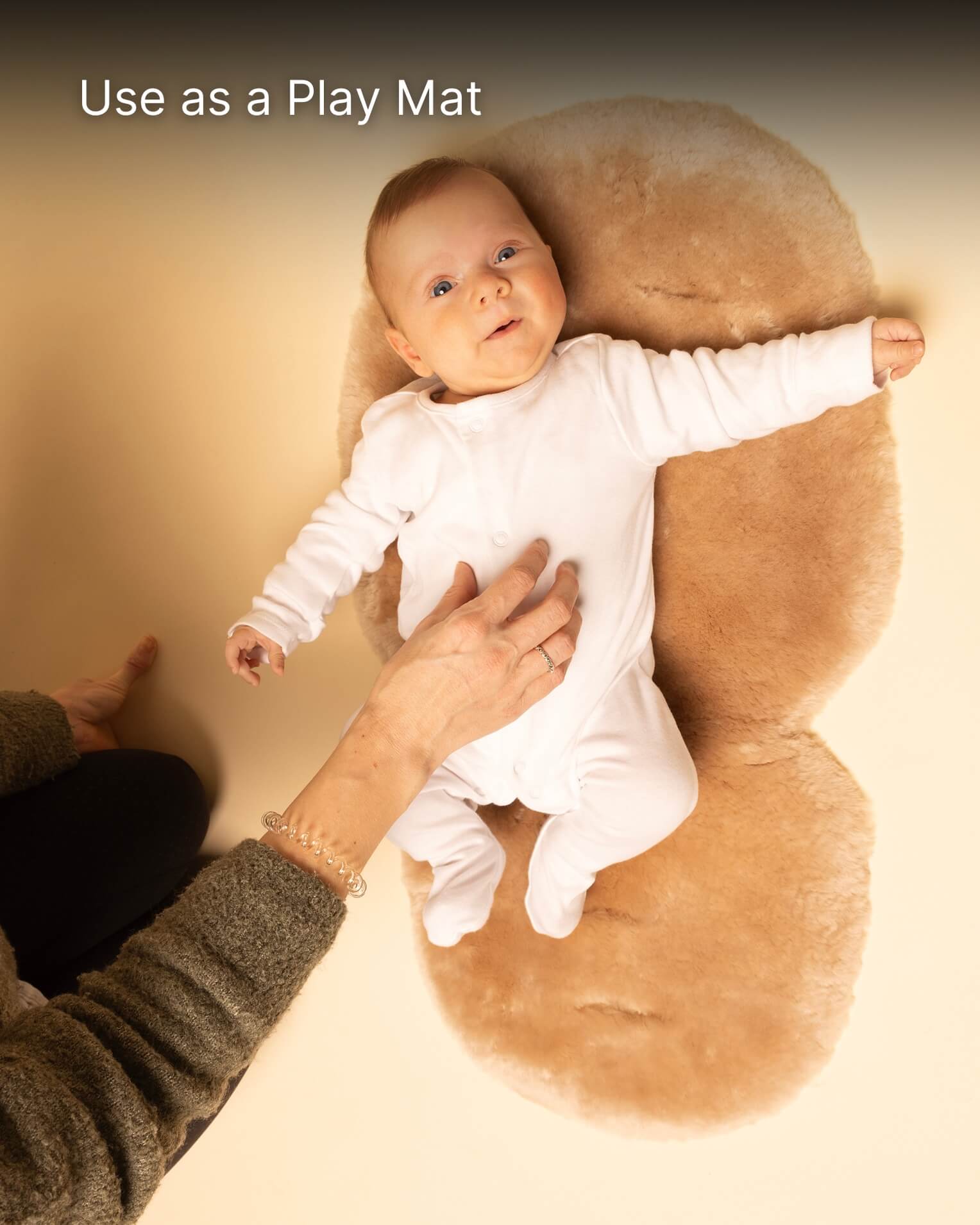 Baby lying on a brown play mat