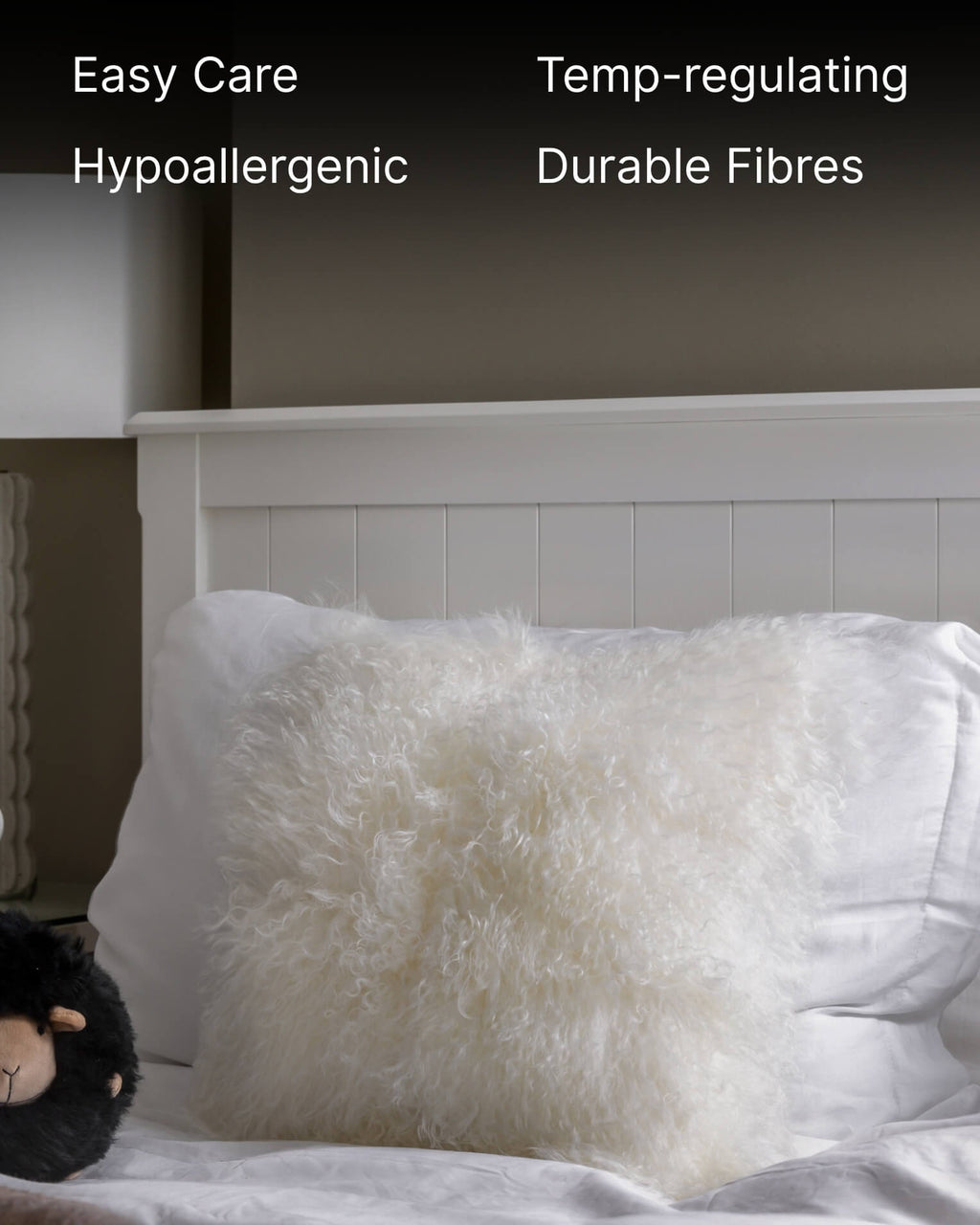 White mongolian sheepskin pillow on bed