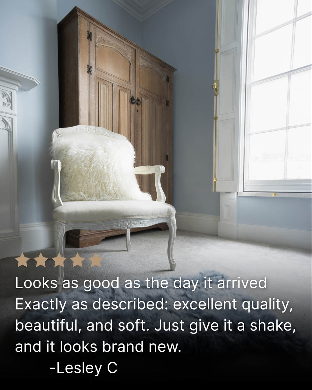 White mongolian sheepskin pillow on single white chair