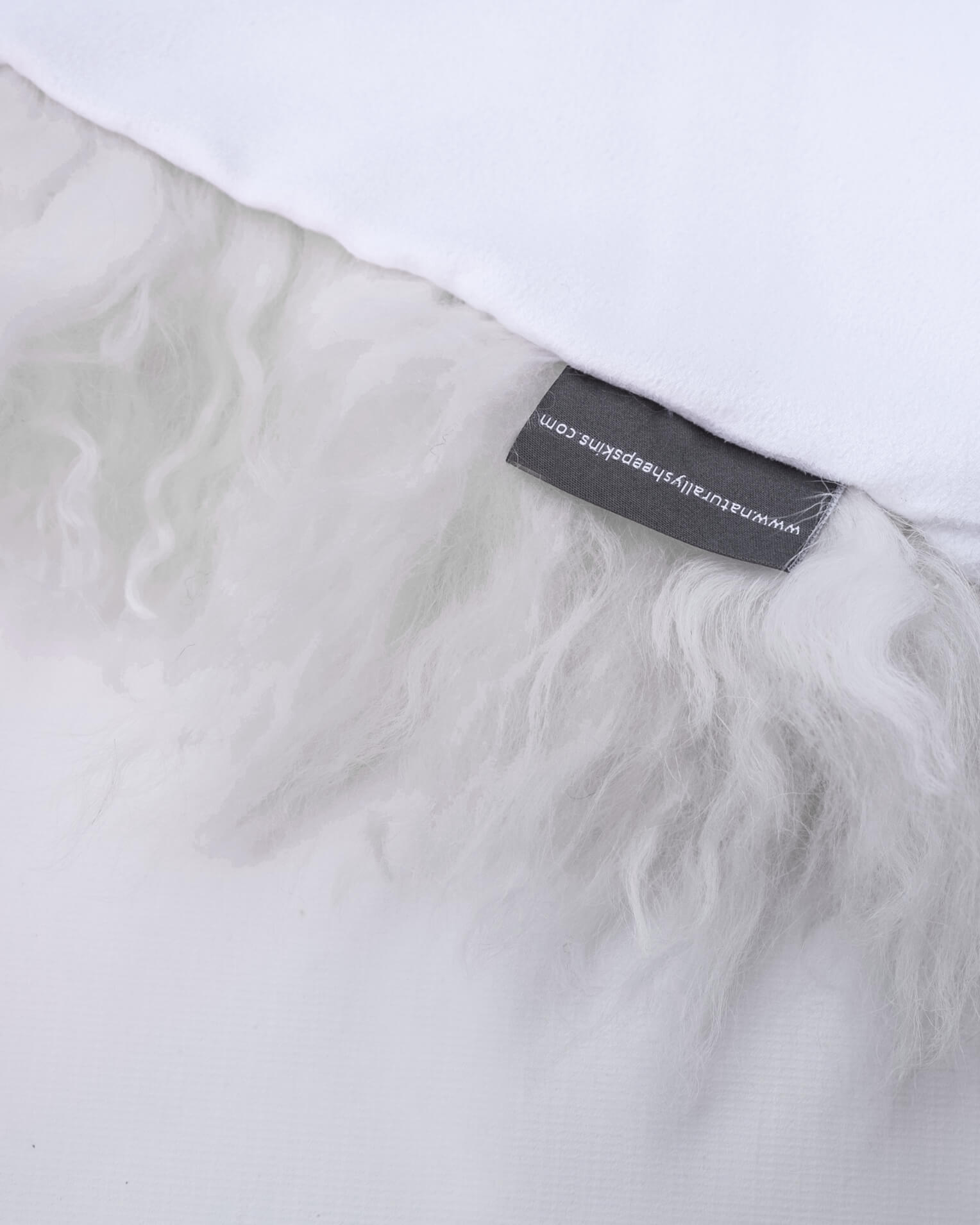 White mongolian sheepskin pillow close up label