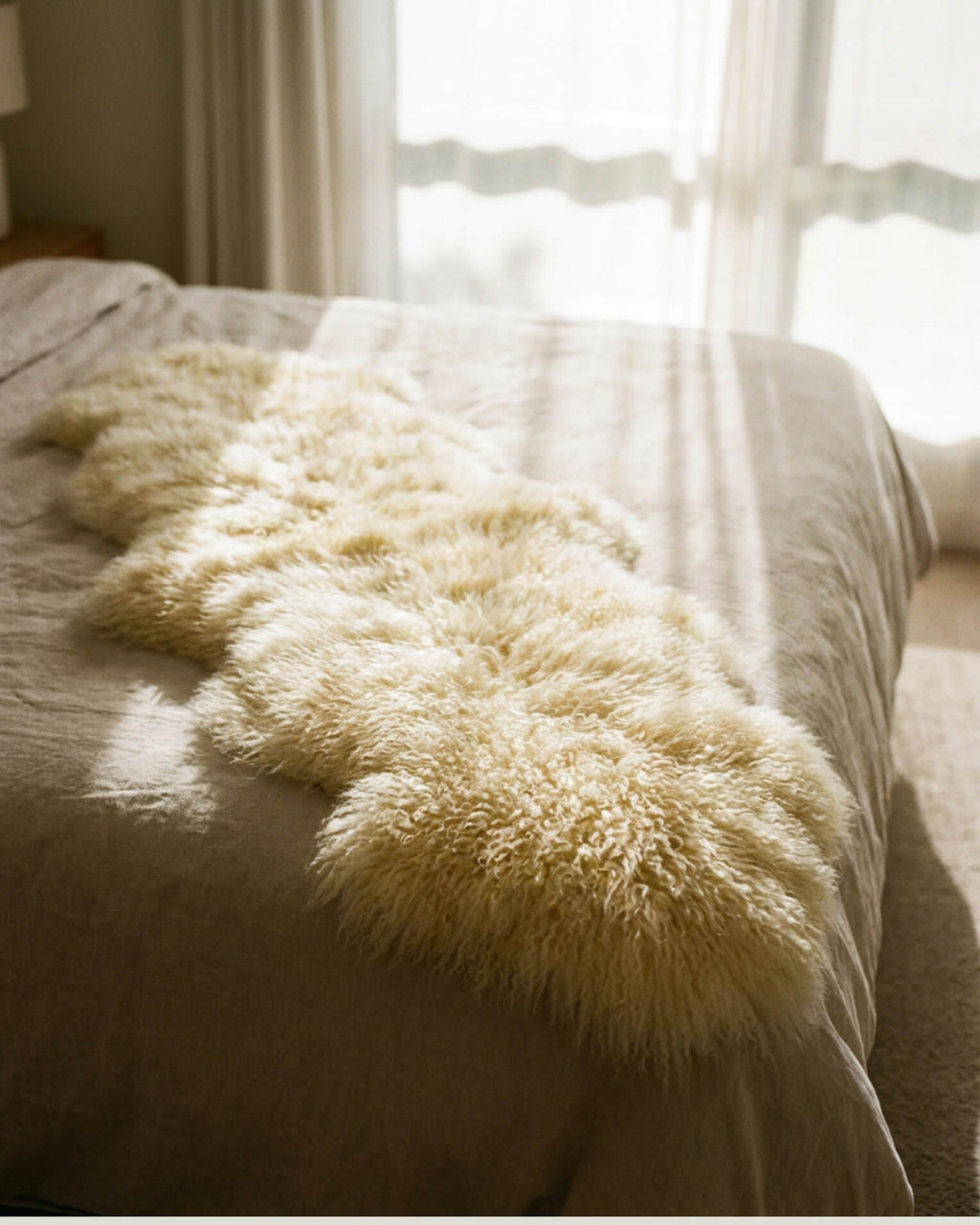 Ivory Mongolian Sheepskin Rug on bed
