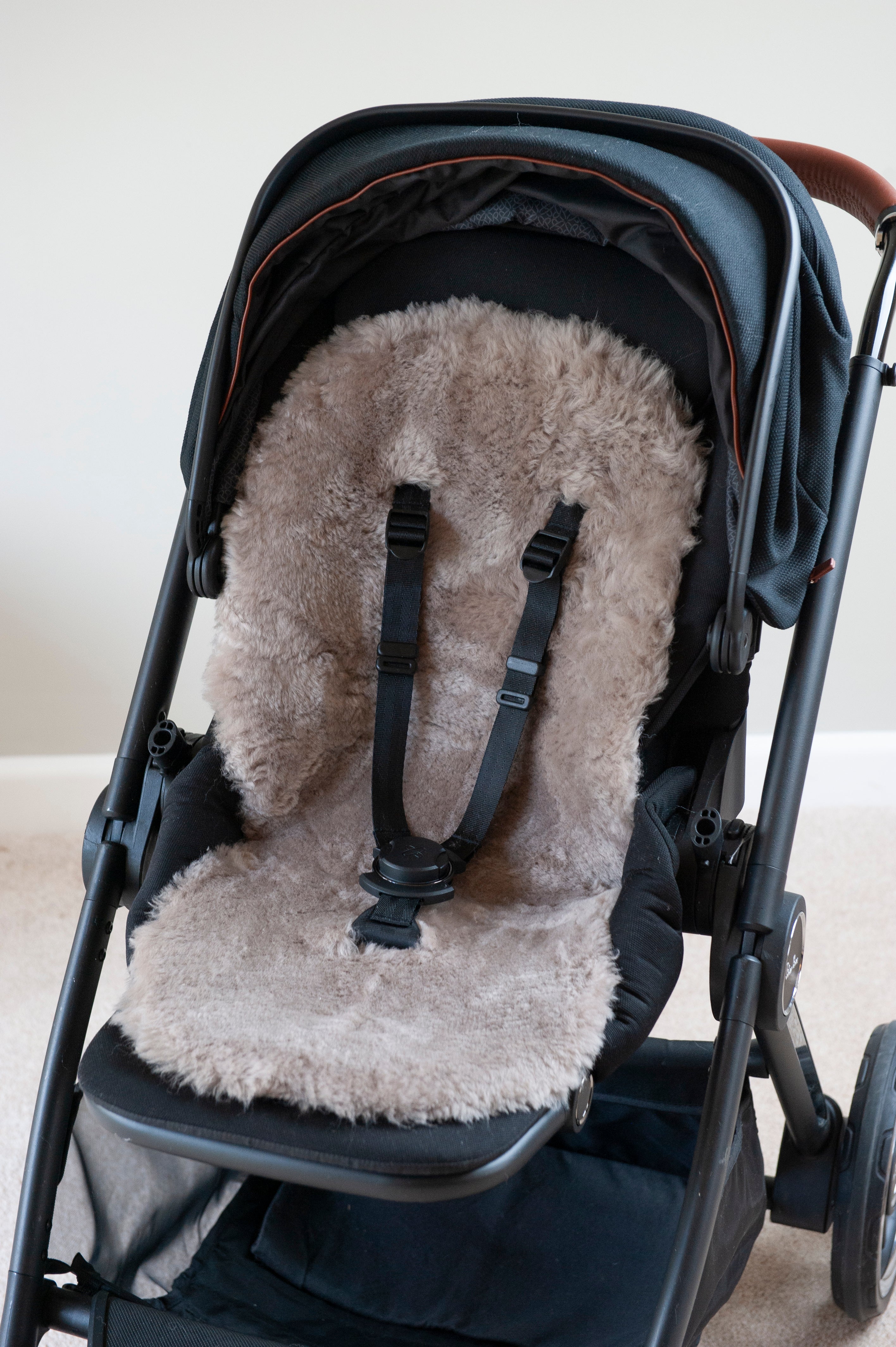 shorn sheepskin pramliner in taupe in pushchair