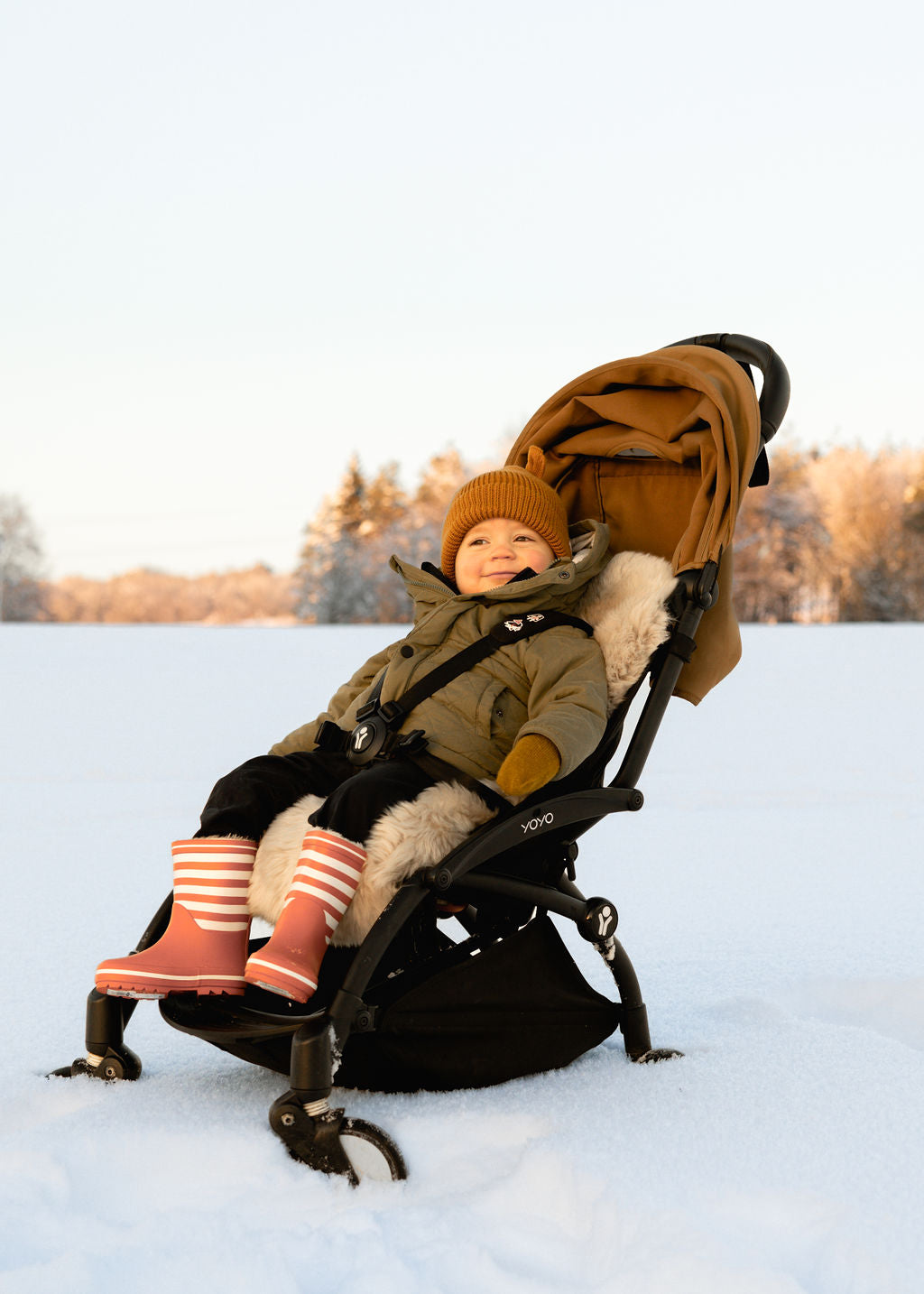 deluxe sheepskin pram liner with baby in pram liner in snow