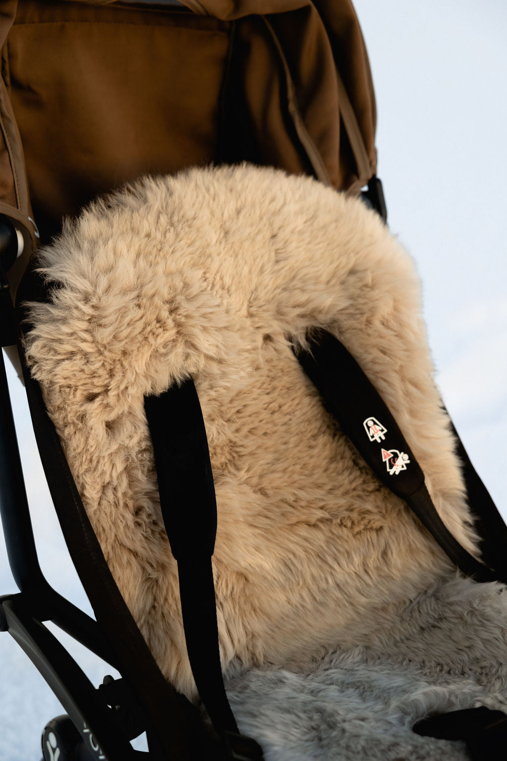 sheepskin deluxe pramliner in pushchair in snow